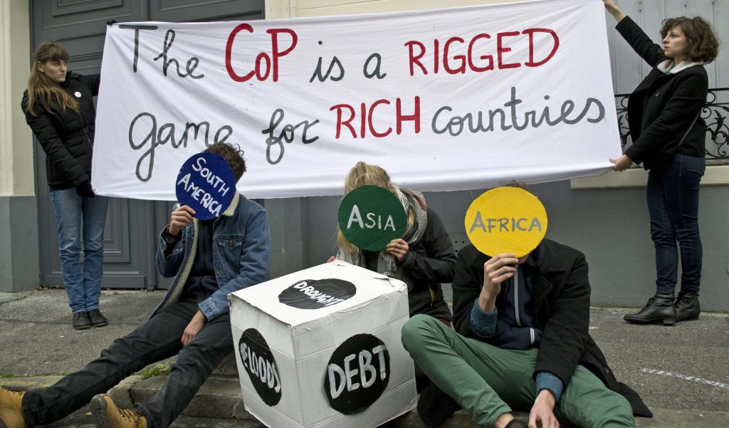 'Climate talks are a rigged game' action by Young Friends of the Earth Europe in Paris