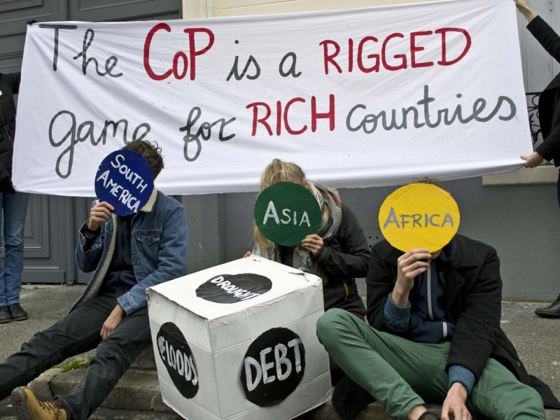 'Climate talks are a rigged game' action by Young Friends of the Earth Europe in Paris