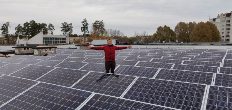 Proud cooperative member with a roof full of solar panels