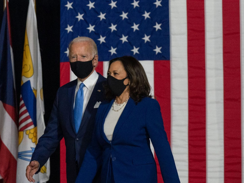 President Joe Biden and Kamala Harris walk onstage