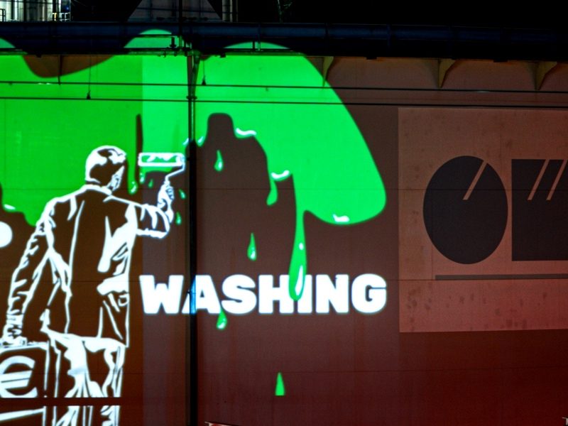 Stop Greenwashing protest projection