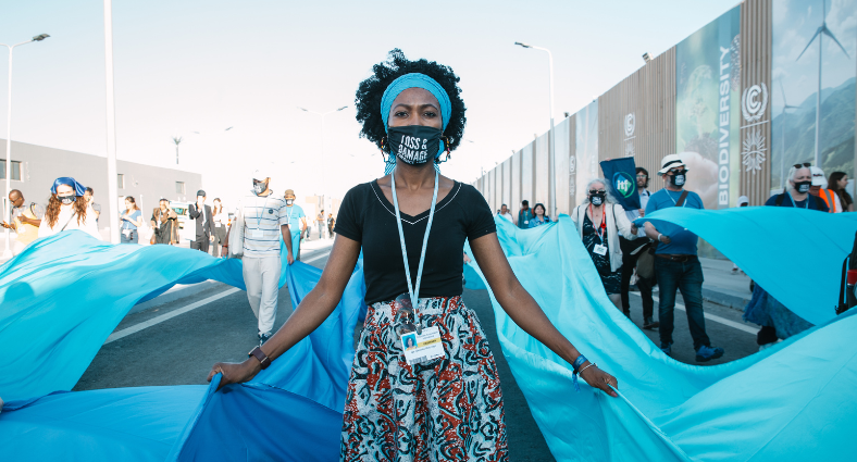 Women dressed in blue “flood” the COP27 to demand loss and damage reparations